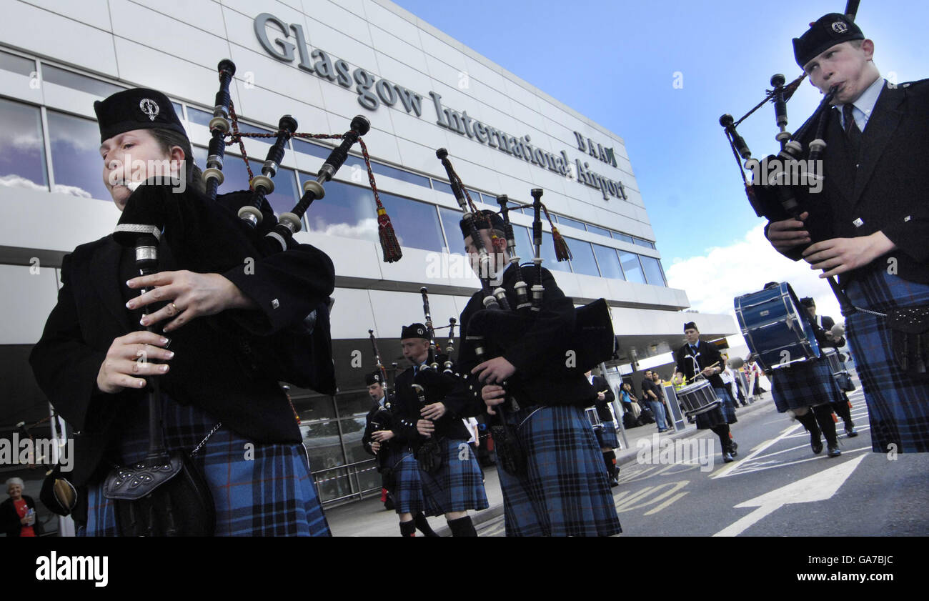 Johnstone Pipe Band performs outside Glasgow Airport ahead of the World Piping Championships. Stock Photo