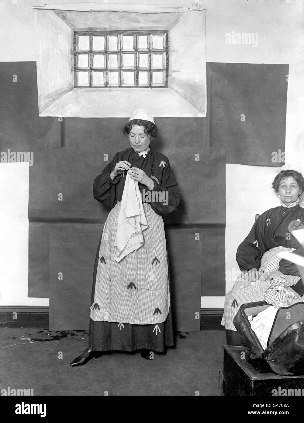 One of the founders of the British suffragette movement Emmeline Pankhurst (right) is seen in Prison costume along with her daughter Christabel. Stock Photo