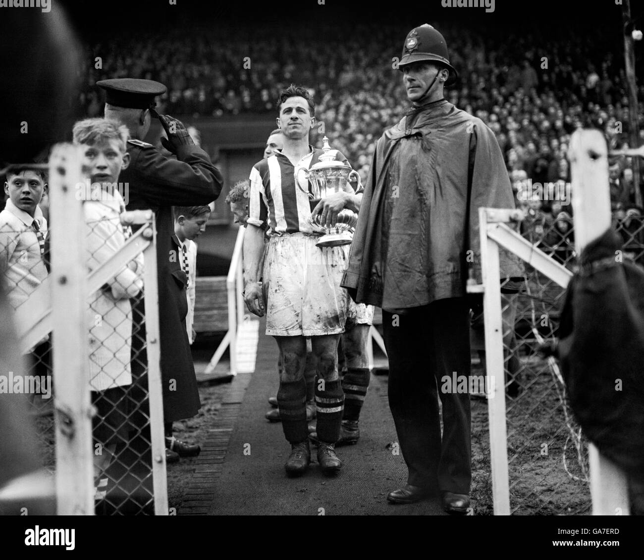 Thomas (Tommy) Glidden, West Brom Captain proudly leaves the stand with