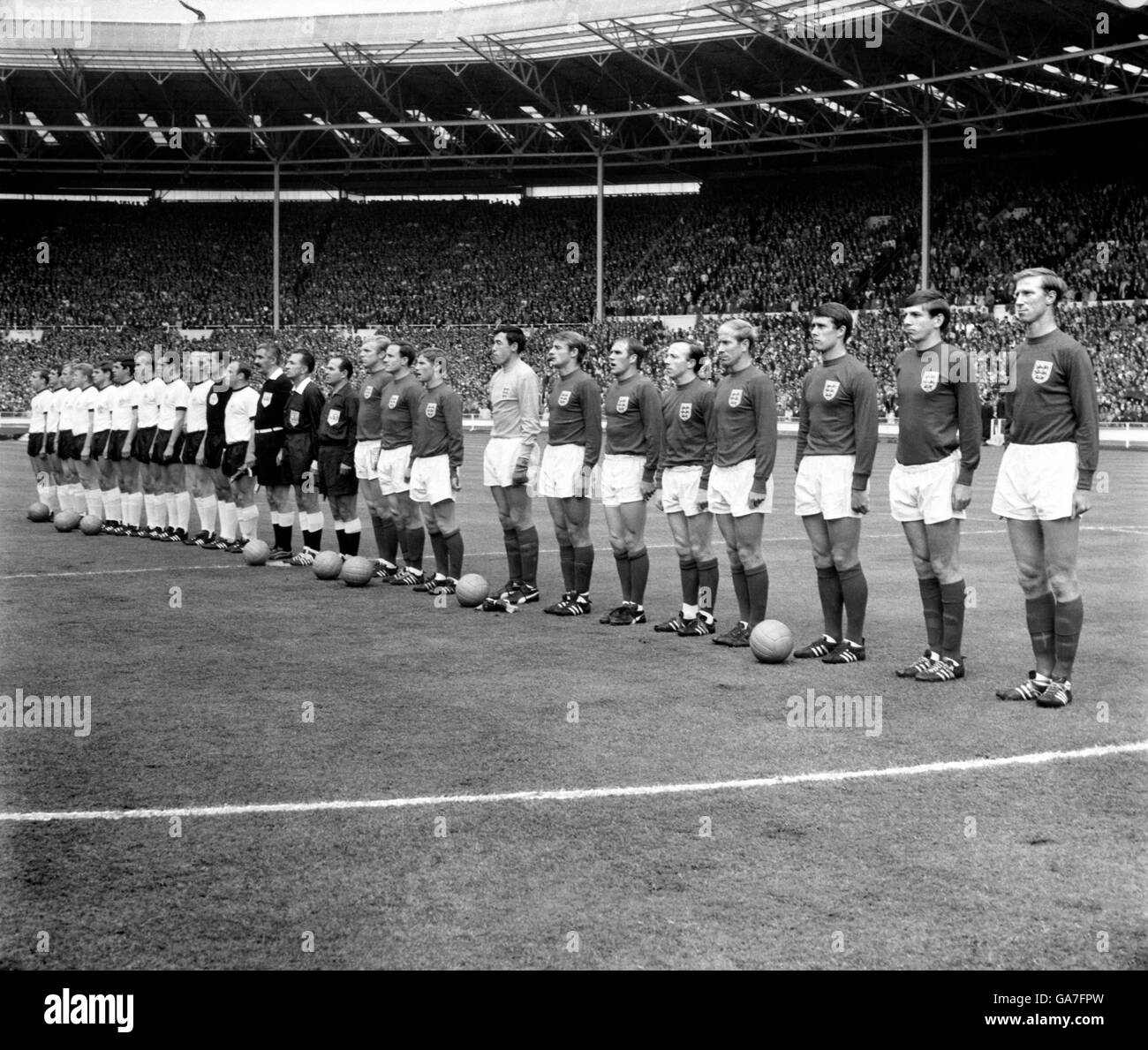 The two teams line up before the match: (l-r) West Germany's Horst-Dieter Hottges, Wolfgang Overath, Siggi Held, Helmut Haller, Wolfgang Weber, Lothar Emmerich, Willi Schulz, Franz Beckenbauer, Karl-Heinz Schnellinger, Hans Tilkowski and Uwe Seeler, linesman Tofik Bakhramov, referee Gottfried Dienst, linesman Karol Galba, England's Bobby Moore, George Cohen, Alan Ball, Gordon Banks, Roger Hunt, Ray Wilson, Nobby Stiles, Bobby Charlton, Geoff Hurst, Martin Peters, Jack Charlton Stock Photo