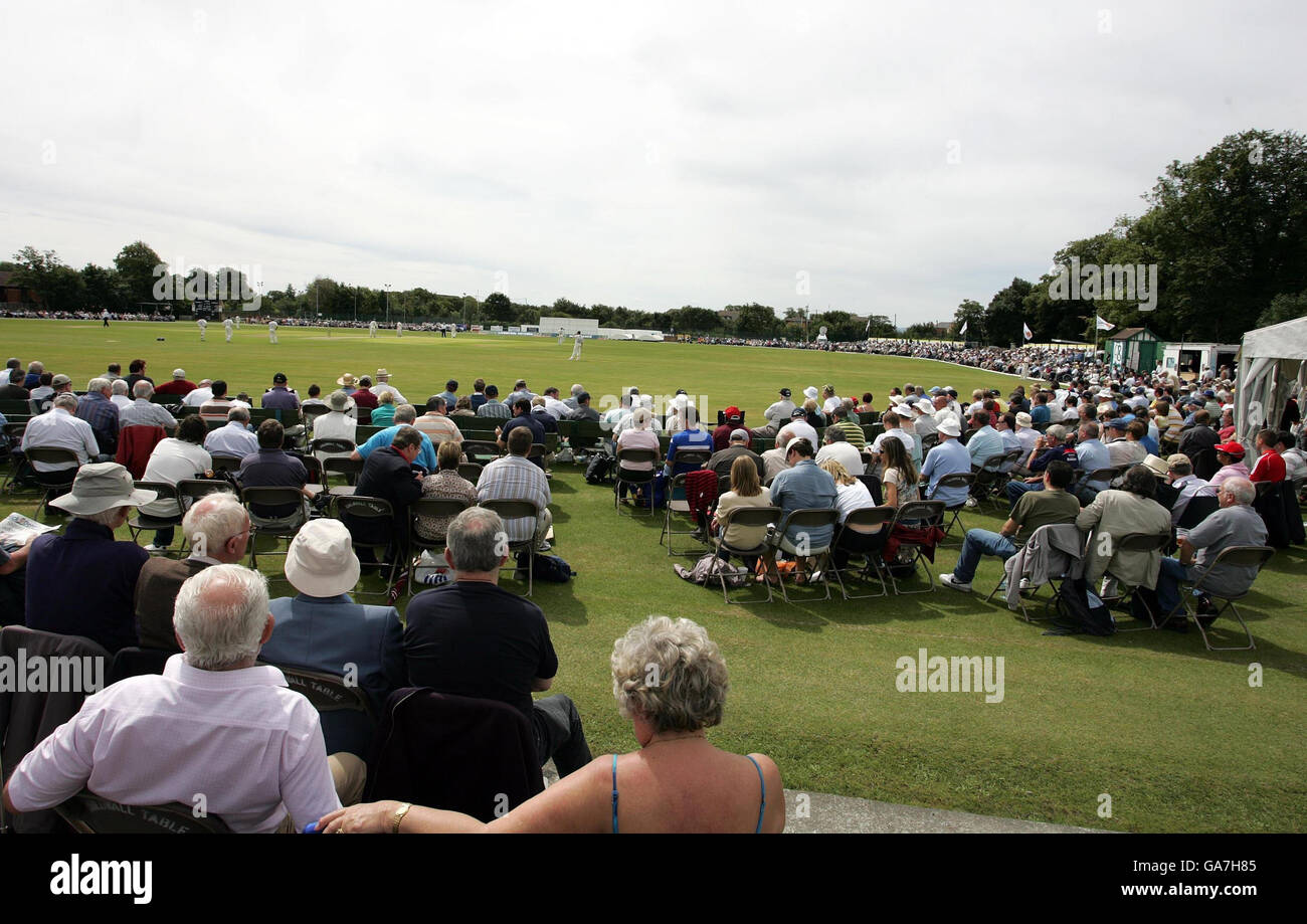 Spectators fill the ground to enjoy the sunshine and cricket during the Liverpool Victoria County Championship Division One match between Lancashire and Sussex at Aigburth Road, Liverpool. Stock Photo