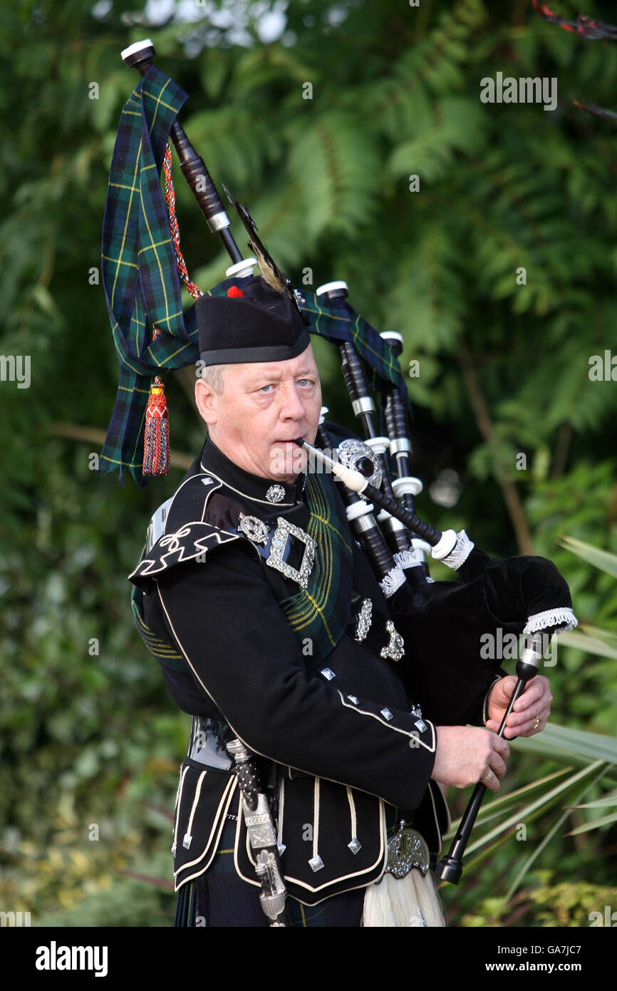 A man playing the Irish Bagpipes performs for visitors during the Irish