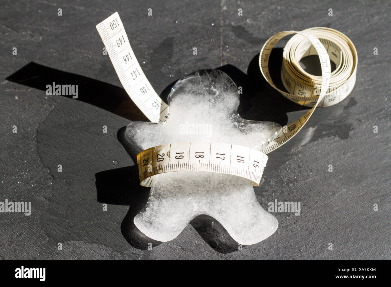 Lost weight and slim abstract concept with ice body melting and measure Stock Photo