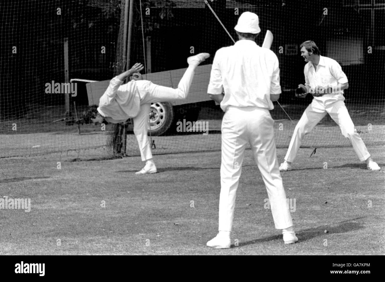Australia's Dennis Lillee (l) stretches to take a catch during fielding practice as teammates Greg Chappell (c) and Ashley Mallett (r) look on Stock Photo