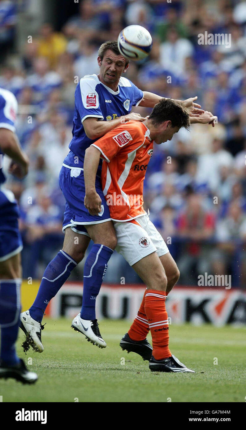 Leicester's Gareth McAauley jumps for the ball with Blackpool's Shaun Barker (right) during the Coca-Cola Football League Championship match at The Walkers Stadium, Leicester. Stock Photo