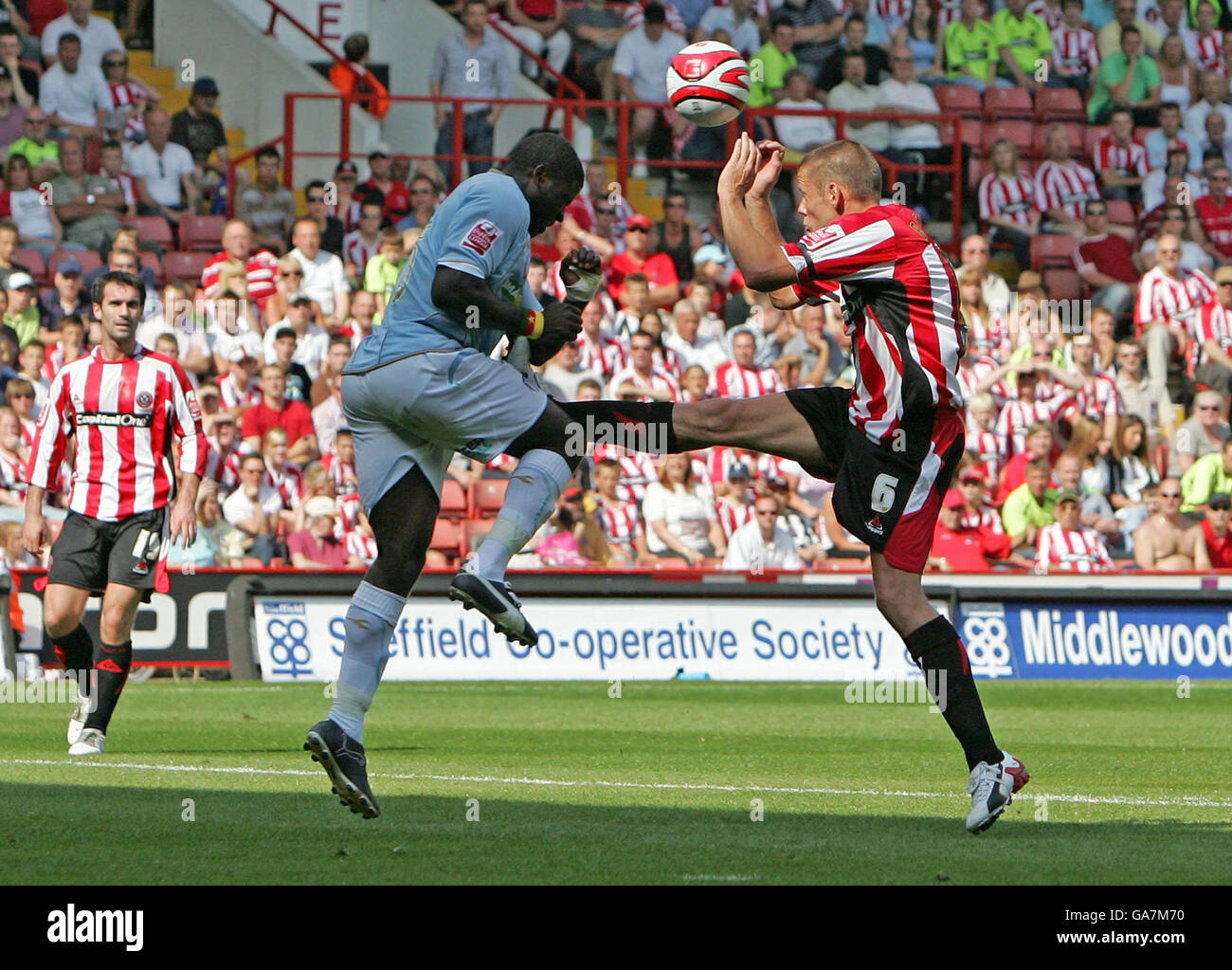 Colchester United's George Elokobi and Sheffield United's James Beattie battle for the ball during the Coca-Cola Football League Championship match at Bramall Lane, Sheffield. Stock Photo