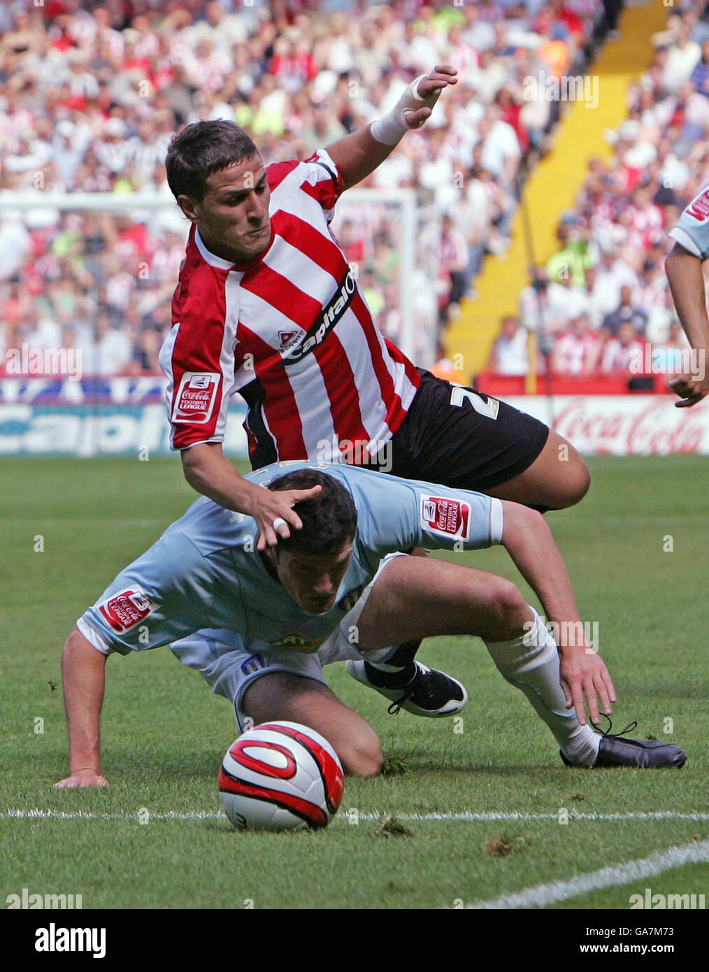 Sheffield United's Billy Sharp runs over Colchester United's Pat Baldwin during the Coca-Cola Football League Championship match at Bramall Lane, Sheffield. Stock Photo