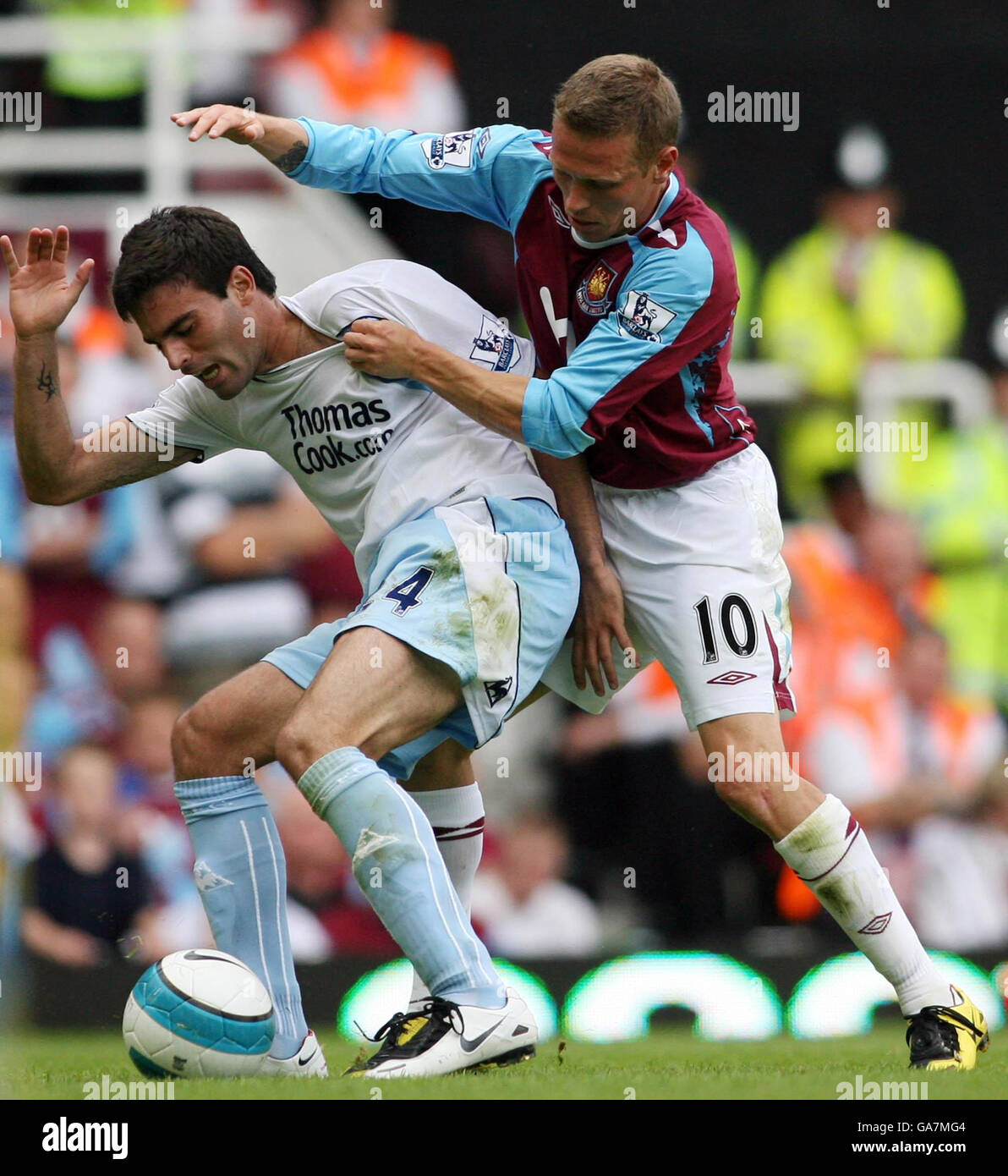 West Ham's Craig Bellamy (right) tackles Manchester City's Javier Garrido during the FA Barclays Premier League match at Upton Park, London. Stock Photo