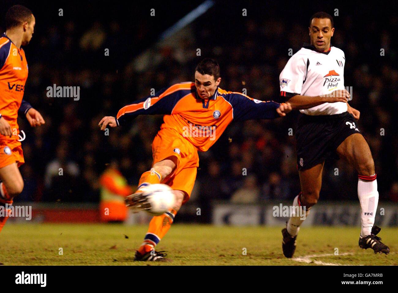 Wycombe Wanderers' Stuart Roberts (c) gets a shot on goal despite the attentions of Fulham's Alain Goma (r) Stock Photo