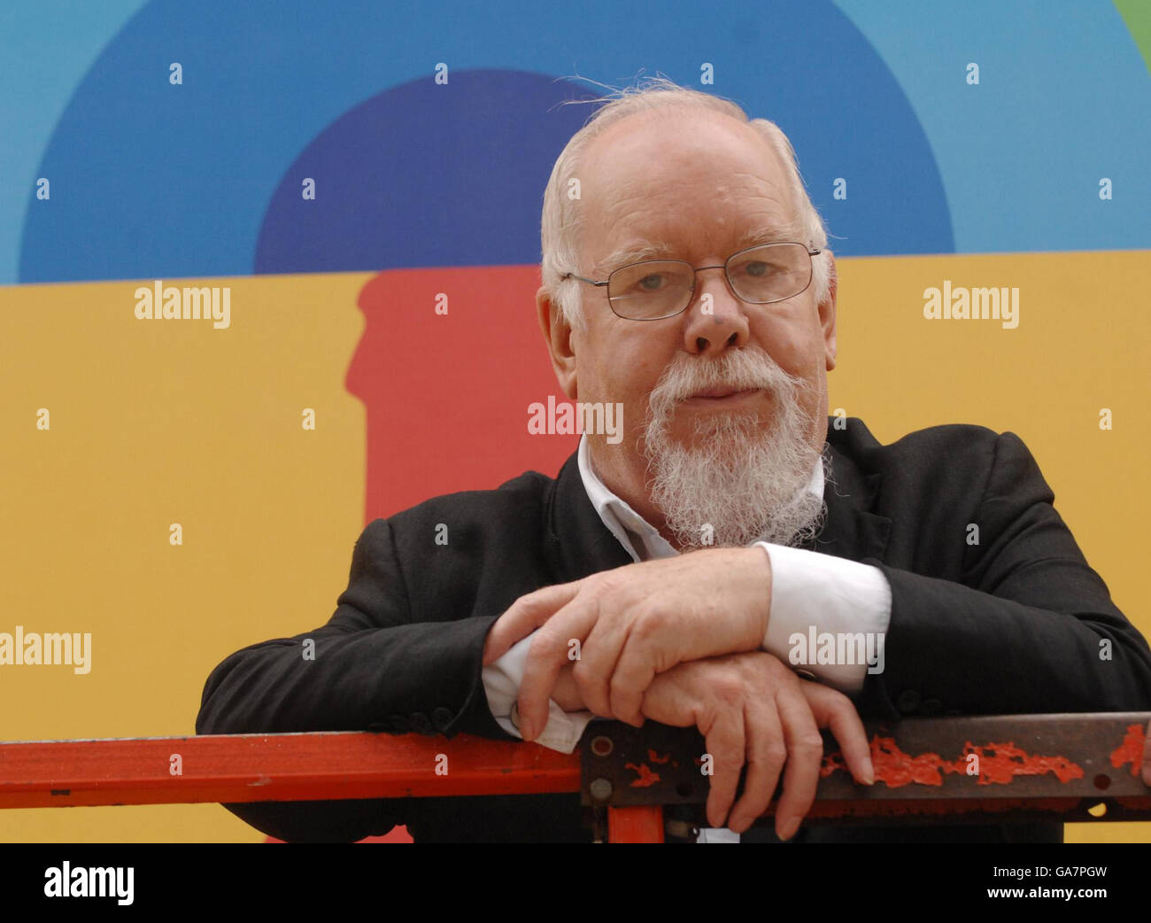 British 'Pop' artist Sir Peter Blake commences work on his 'Coke Side Of Life' theme artwork, fixing a burlesque type transfer onto a 20ft poster on the South bank in London. Stock Photo