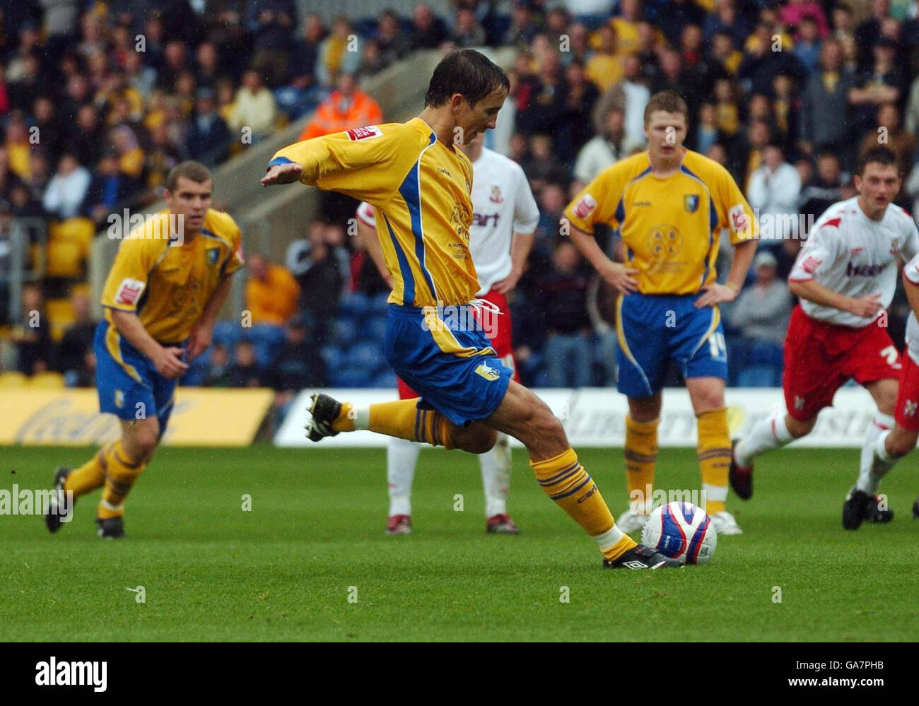 Mansfield Town's Michael Boulding scores from the penalty spot during the Coca-Cola Football League Two match at Field Mill, Mansfield. Stock Photo