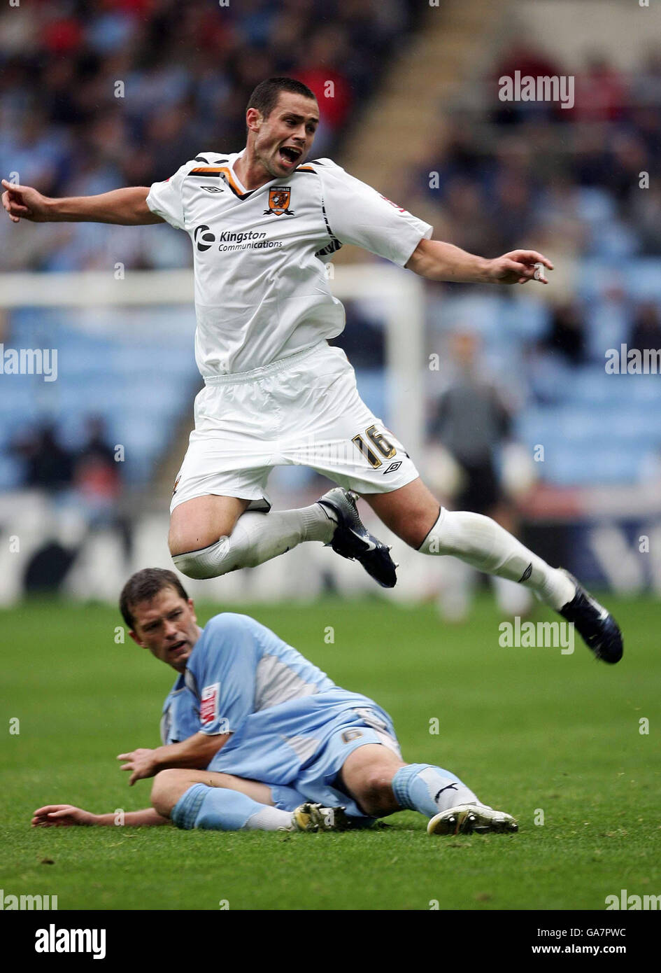 Hull's Damien Delaney clears a challenge from Coventry's Stephen Hughes during the Coca-Cola Football League Championship match at Ricoh Arena, Coventry. Stock Photo