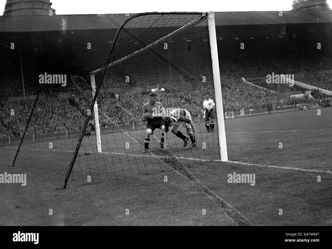 Joe Payne (Chelsea) tries to charge Sam Bartram into the net. Bartram, usually Charlton goalkeeper was a guest player for Millwall. Chelsea won the wartime match 2-0. Stock Photo