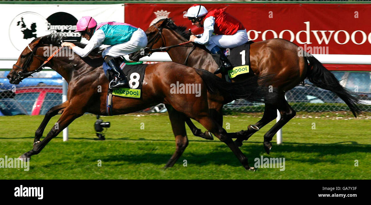 Horse Racing - Goodwood. Richard Hughes rides Sense of Joy (left) to victory in The Prestige Stakes at Goodwood Racecourse. Stock Photo