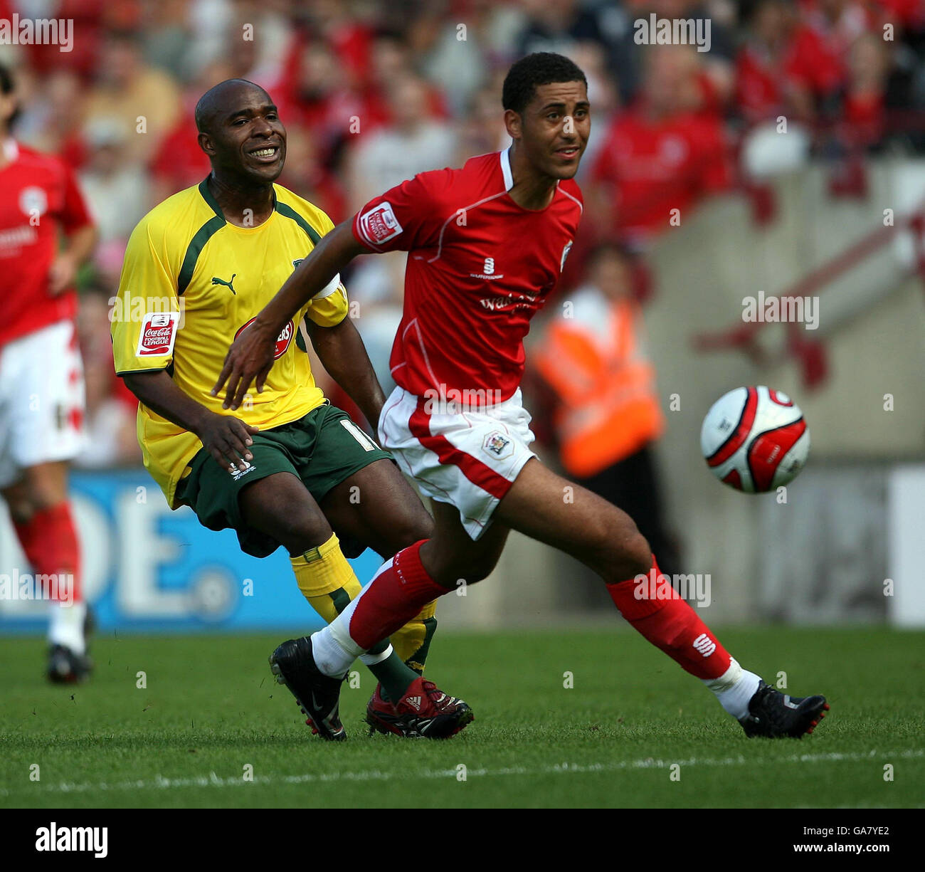 Barnsley's Lewin Nyatanga and Plymouth Argyle's Barry Hayles in action during the Coca-Cola Football League Championship match at the Oakwell Ground, Barnsley. Stock Photo