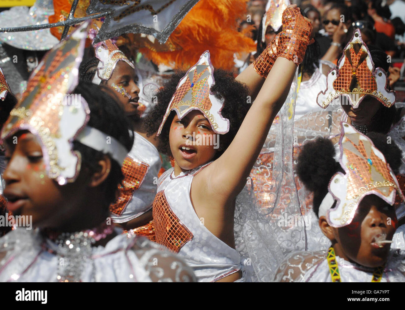 Carnival revellers join the procession of junior entrants in the Notting Hill Carnival's children's day. Stock Photo