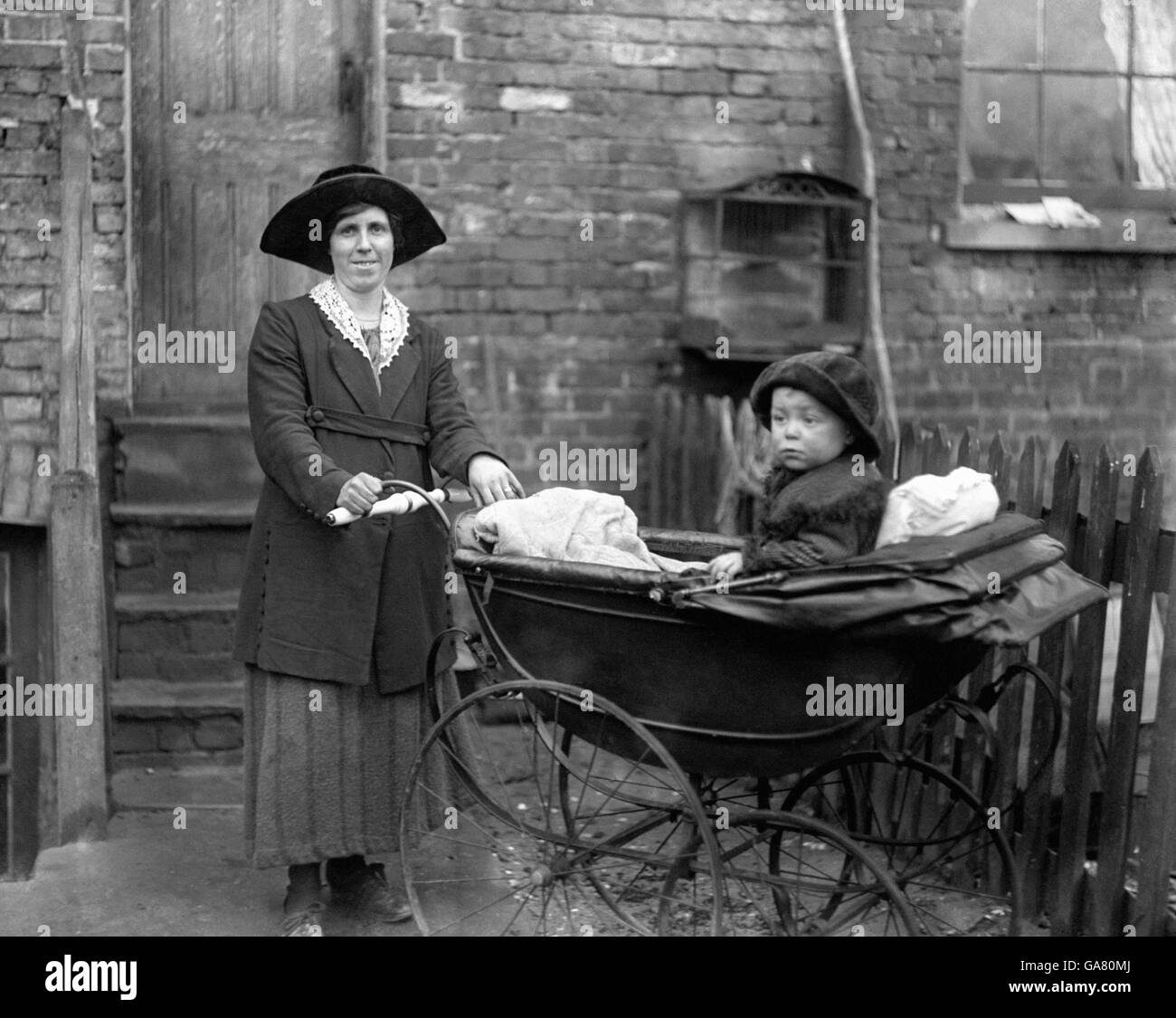 Aged 29 and mother of three children, Mrs Rose Firmarger, of Erith, and her two-year-old baby have started active training on Kentish roads for the mothers' perambulator walking race to Brighton, in which each competitor has to push a perambulator and a baby. Mrs Firmarger's training course is a circular 30-mile route from Erith to Farnborough, returning via Bromley, Lewisham and Greenwich. Stock Photo