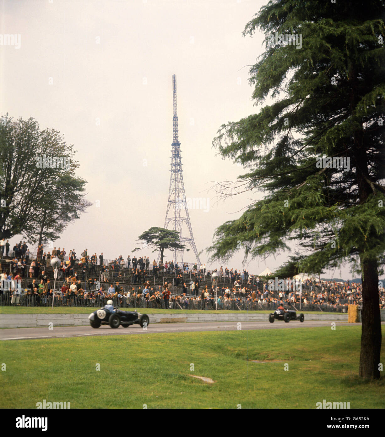 Two veteran racing cars on the straight at the two Crystal Palace circuit during a cavalcade of Speed for cars of all ages. In background is the Crystal Palace television mast Stock Photo