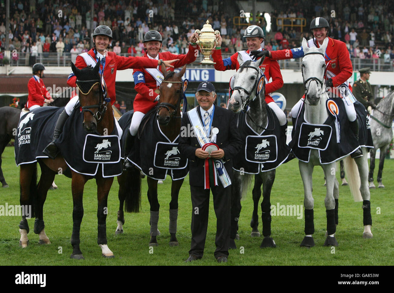 Germany's Chef d'Equipe Sonke Sonksen (front) and team (left to right) Thomas Muhlbauer, Engemann Hermann, Holger Wulschner and Thomas Voss hold up the Aga Khan Challenge trophy at the Dublin Horse Show at the RDS, Dublin. Stock Photo