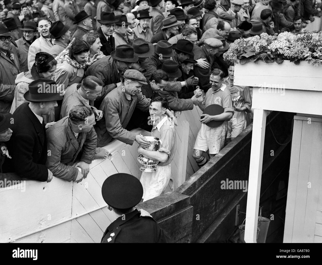Soccer - FA Cup Final - Arsenal v Liverpool - Wembley Stadium. Arsenal Captain Joe Mercer is mobbed by their fans after receiving the FA Cup Trophy. Stock Photo