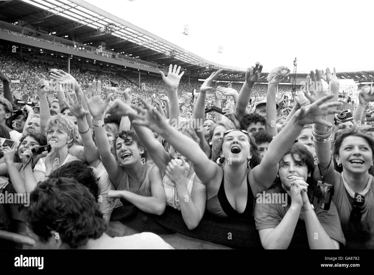 Adoring Wham fans pay homage to their heroes, George Michael and Andrew Ridgeley when the stars bounded onto the Wembley Stadium stage for their sell-out farewell concert. Some 75,000 were said to be there to see the duo's final appearance together after four years. Stock Photo