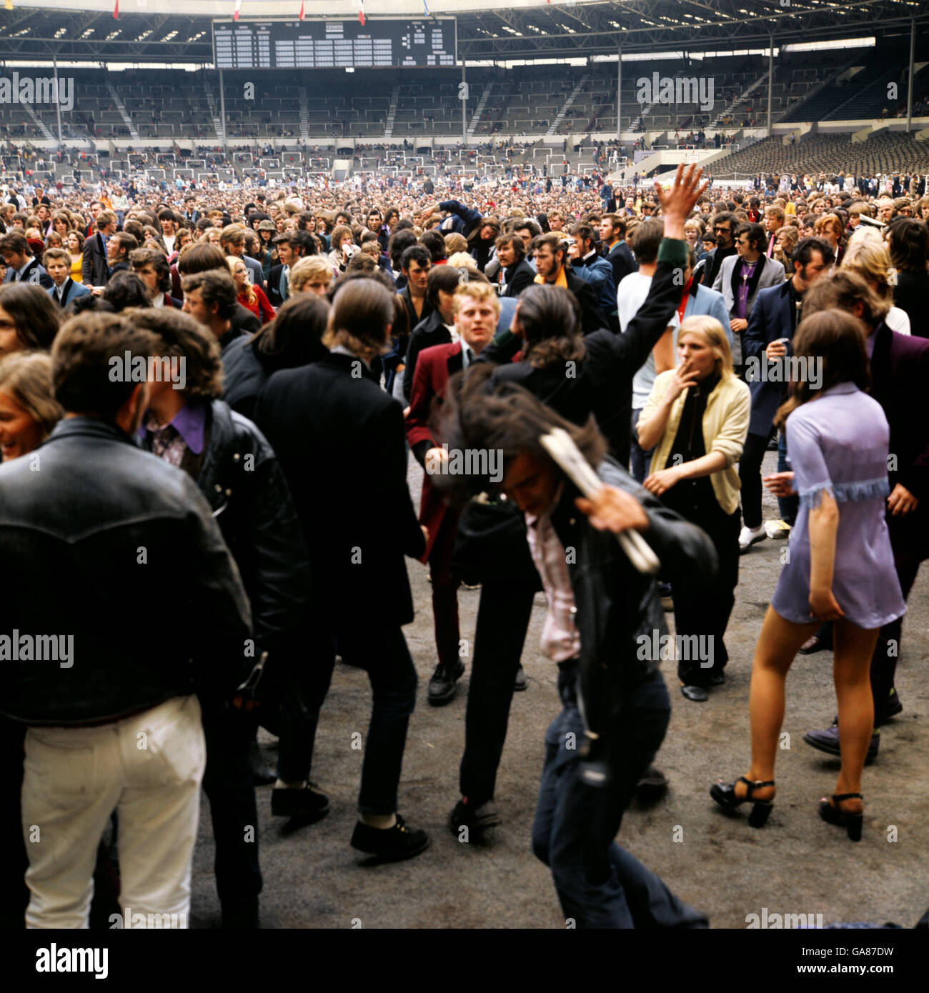 Some of the thousands of rock fans are seen at the Rock 'n' Roll festival at Wembley Stadium wearing fashions of the fifties. Stock Photo