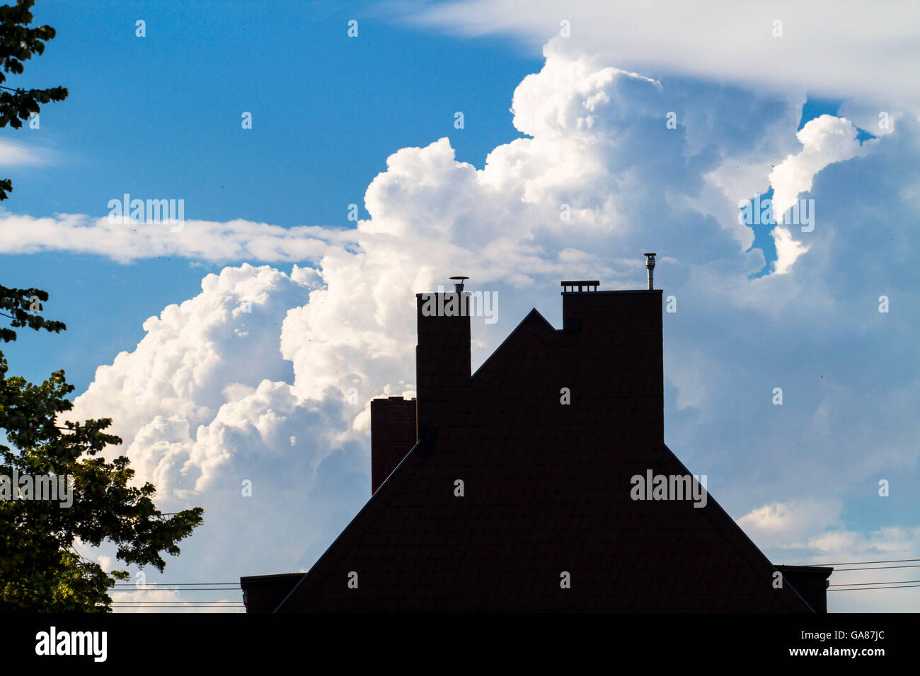 Europe, Germany, Cologne, thunder clouds above gable. Stock Photo