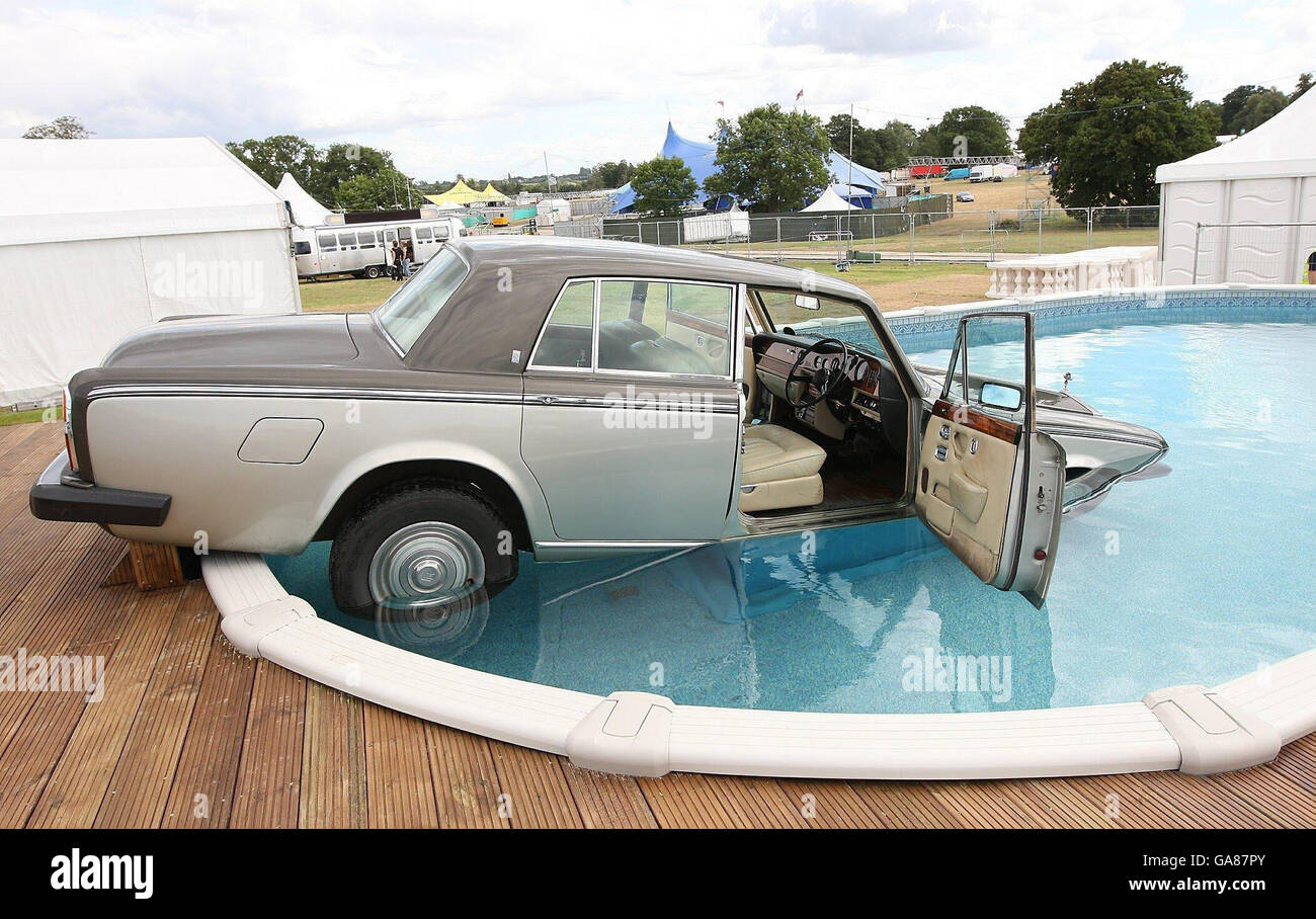 The Rolls Royce of Virgin Radio DJ Suggs lies in a swimming pool where it  was deposited after he lost an on-air bet with fellow DJ Christian  O'Connell, Chelmsford, Essex Stock Photo -