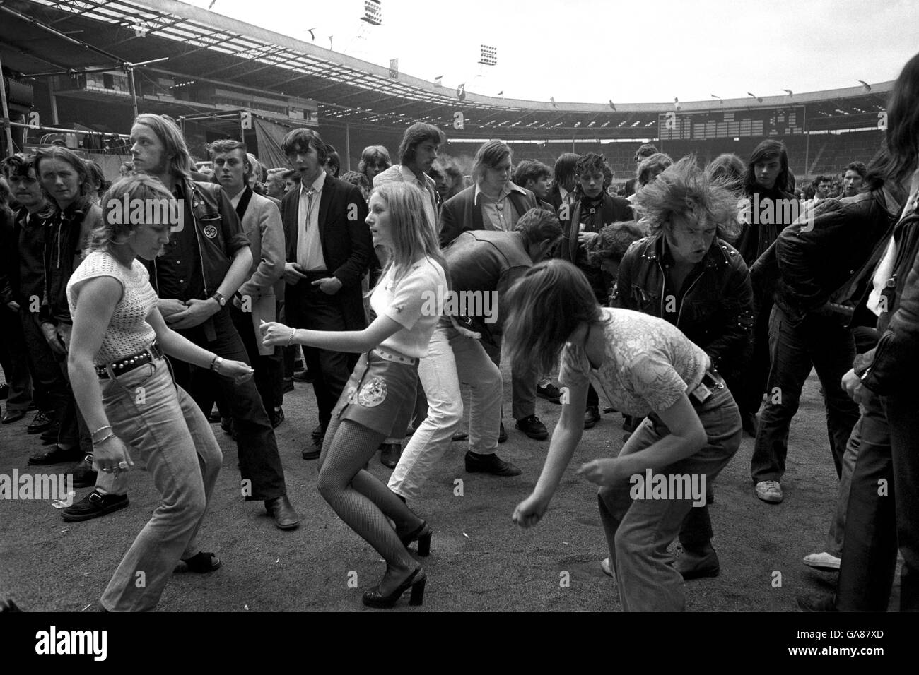 Rock enthusiasts at Wembley Stadium where many thousands attended a Rock 'n' Roll festival, sporting fashions of two decades ago. Stock Photo