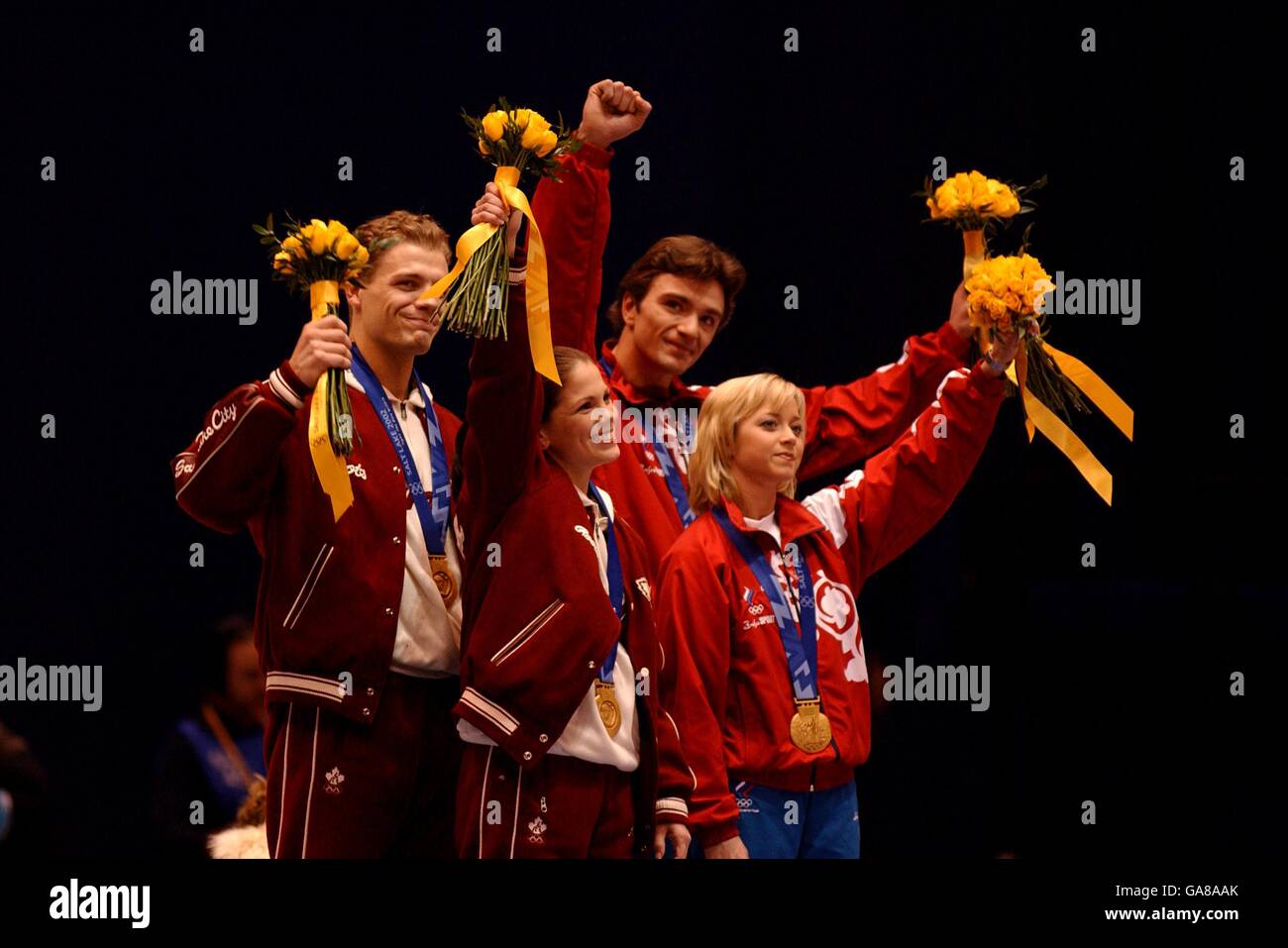 l-r; Canada's Jamie Sale and partner David Pelletier with their Gold medal's along with Russia's Elena Berezhnaya and partner Anton Sikharulidze (the original winners of the pairs competition) who also hold their gold medal's Stock Photo
