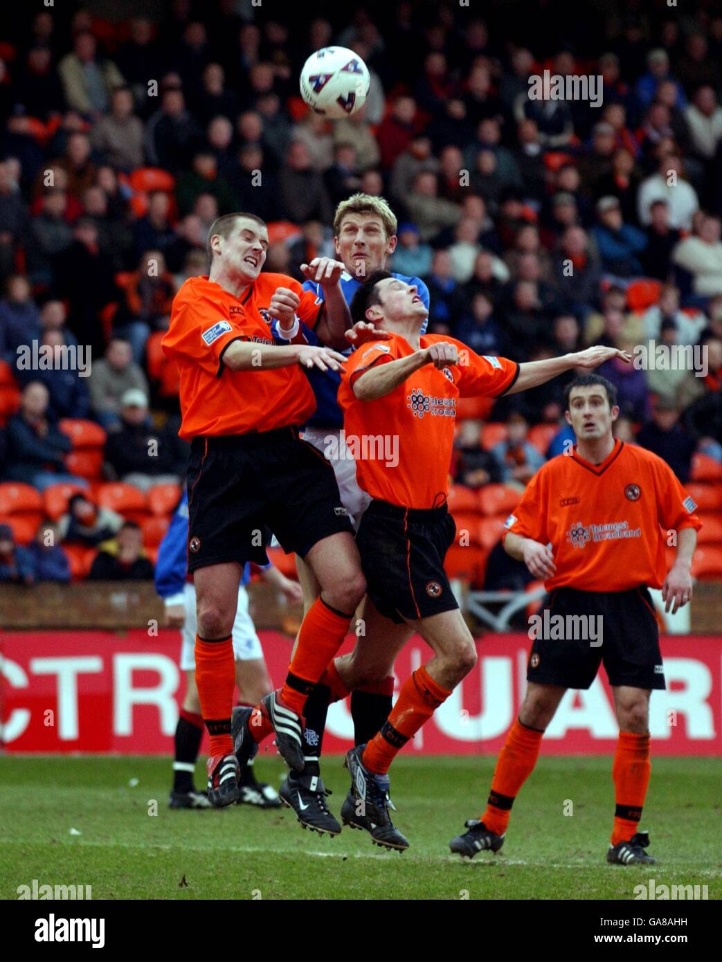 Rangers' Tore Andre Flo (c) jumps for a header with Dundee United's Danny Griffin (l) and Craig Easton (r) Stock Photo