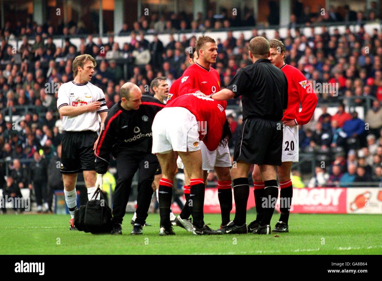 Manchester United's players surround the referee following a challenge ...