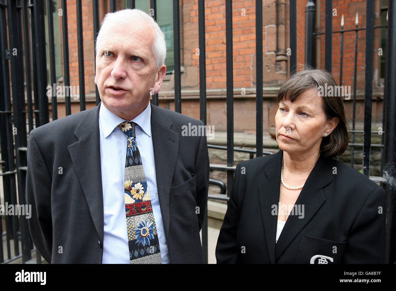 Sam Torney (left) is accompanied by his wife Hilary as he leaves an inquest into the death of his brother John Torney, at Belfast Coroners court. Stock Photo