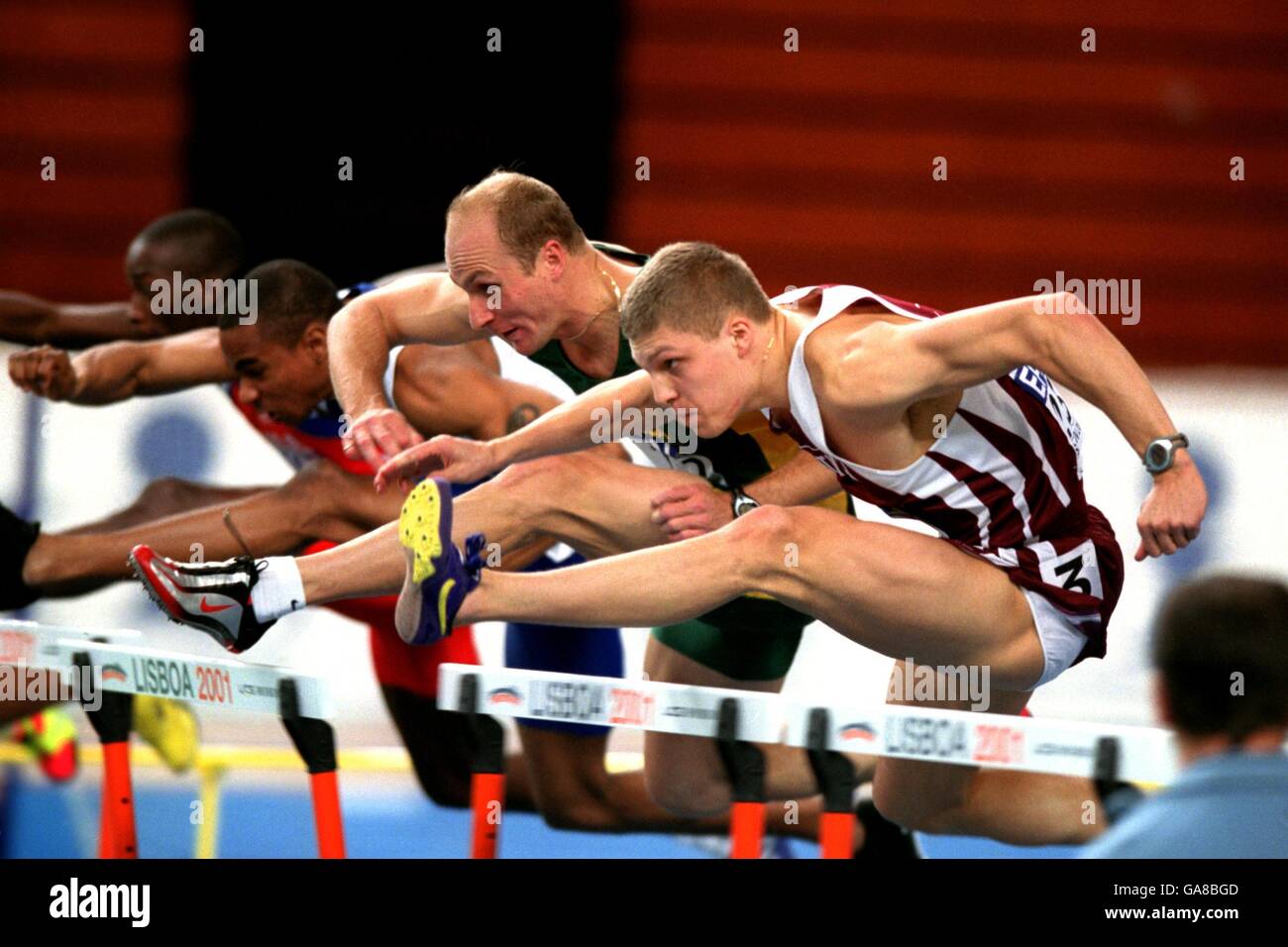 Athletics - IAAF World Indoor Championships 2001 - Lisbon. South Africa's Shaun Bownes (l) and Stanislavs Olijars (r) in action during the Men's 60m Hurdles Stock Photo