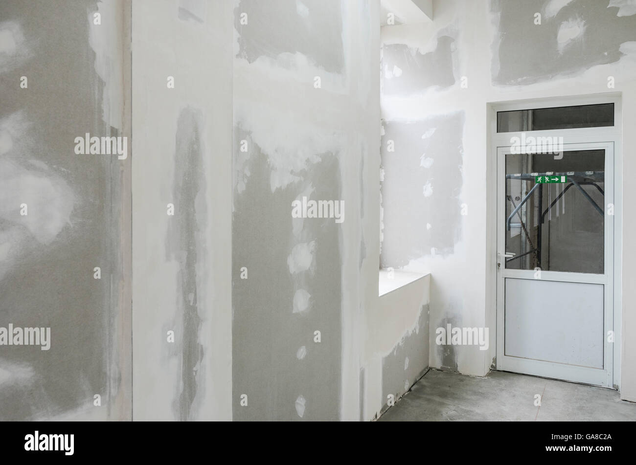 unfinished walls with gypsum and white door Stock Photo