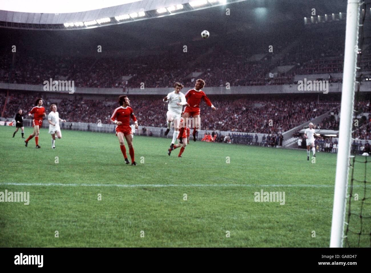 (L-R) Bayern Munich's Franz Beckenbauer looks on as Leeds United's Allan Clarke leaps for a header Stock Photo