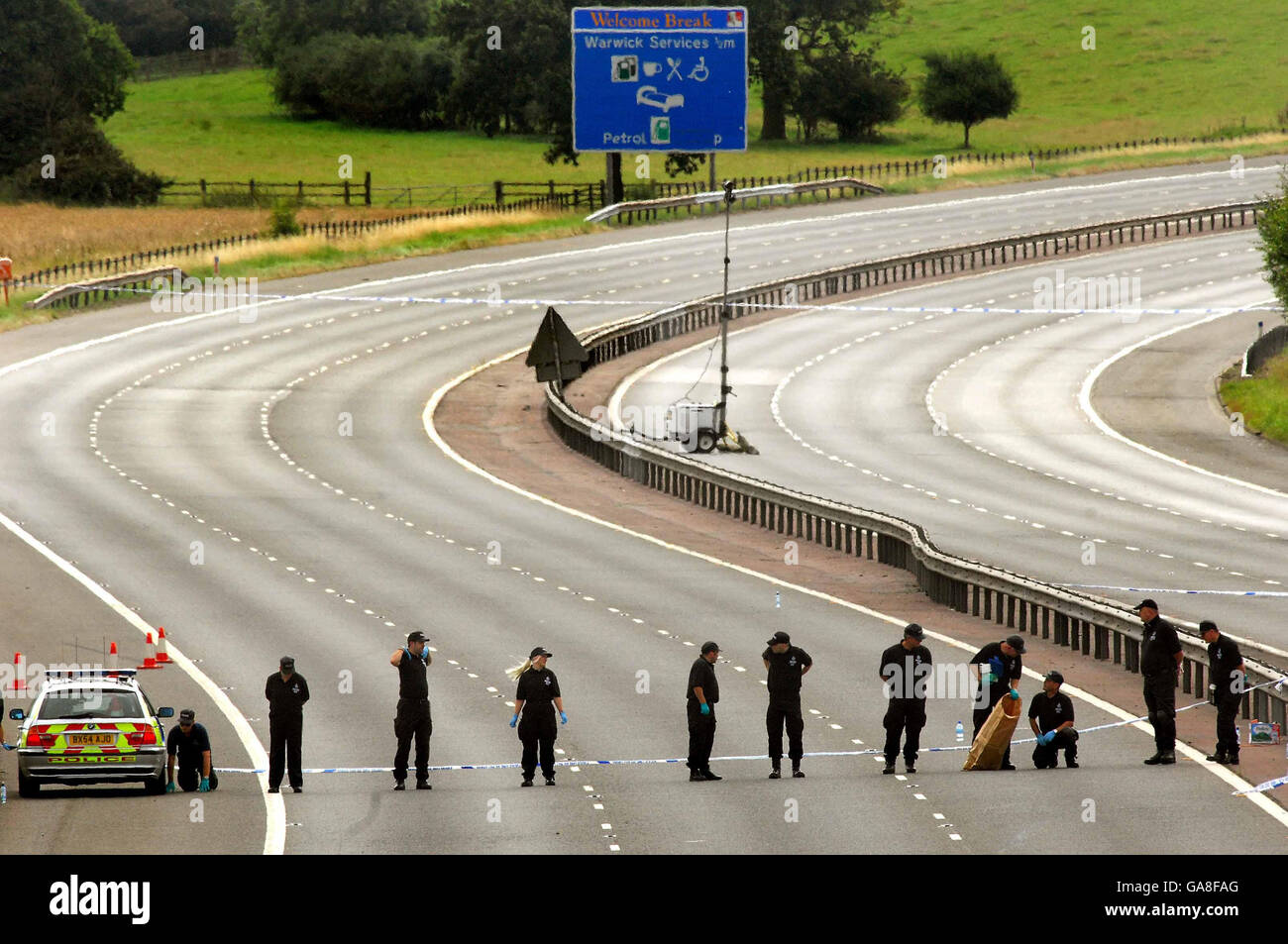 Police carry out a painstaking search of the M40 in Warwickshire, where a motorcyclist was gunned down after visiting the Bulldog Bash biker festival on Sunday. Stock Photo