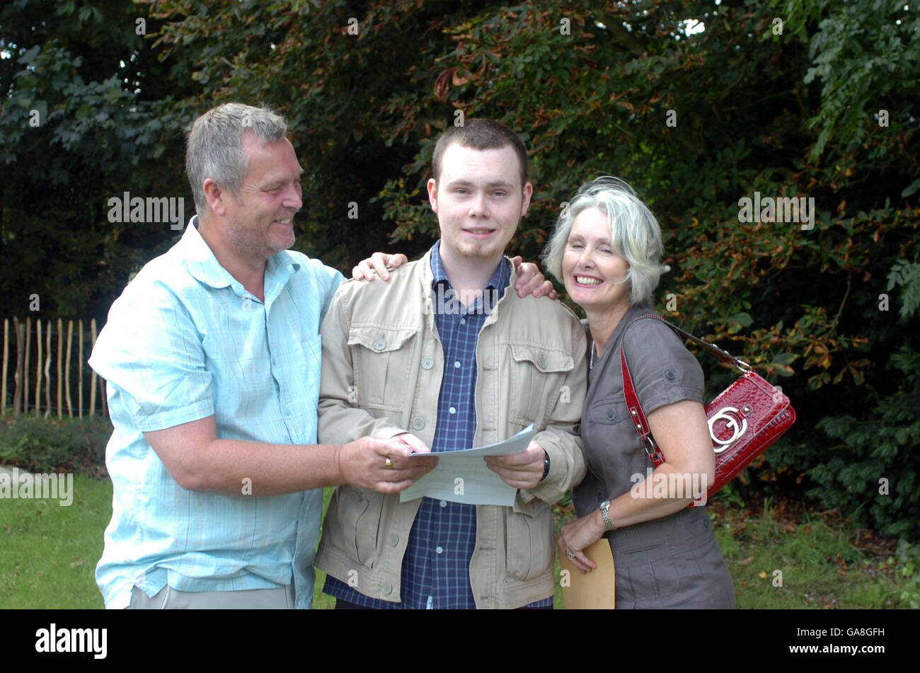 A-level results announced. Jos Gibbons with his parents Neil and Susan as he gets his A Level results in Birmingham. Stock Photo