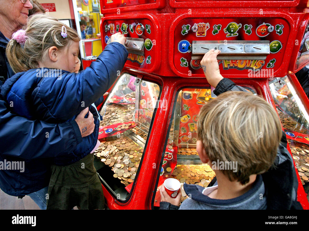 Children play in the seaside amusement arcades as bad weather draws holidaymakers indoors at Weston-Super-Mare in Somerset. Stock Photo
