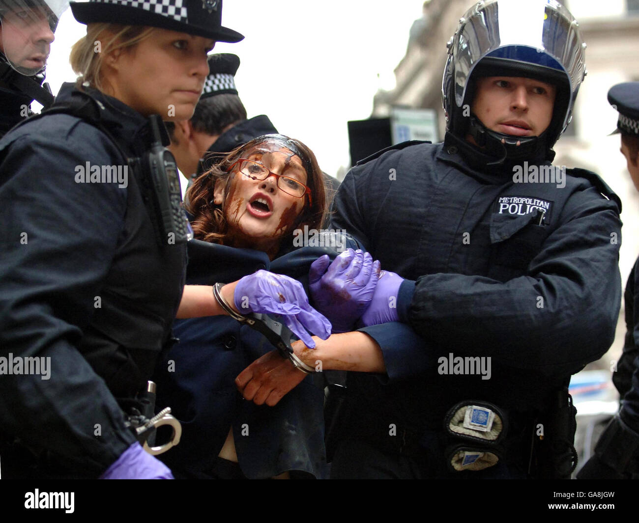 An environmental campaigner is removed from the headquarters of the oil company BP in St James's Square, central London, after protesting at BP's provision of fuel to Heathrow airport. Stock Photo