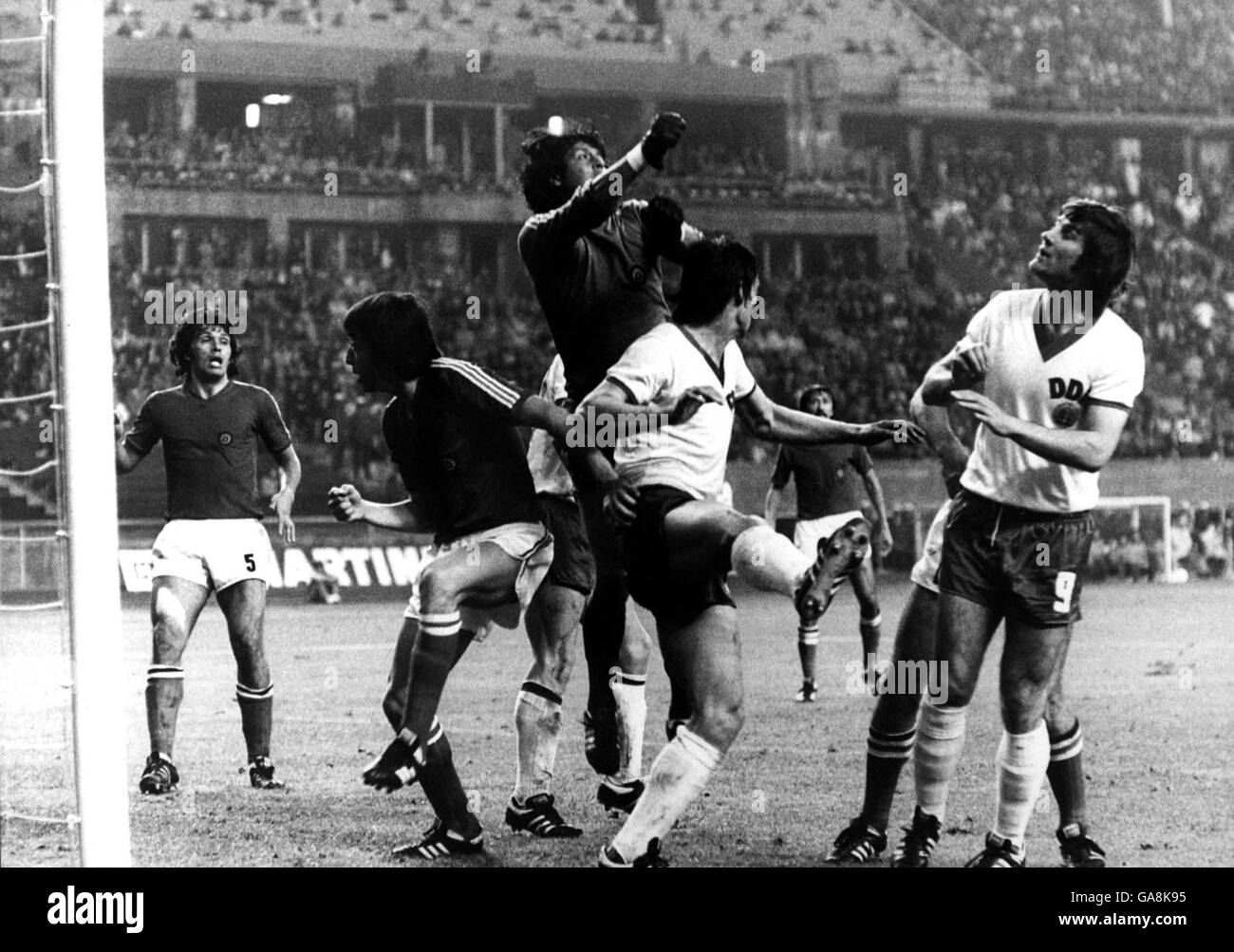 Chile goalkeeper Leopoldo Vallejos (c) punches clear from East Germany's Wolfgang Seguin (second r) and Peter Ducke (r), watched by teammates Elias Figueroa (l) and Ronaldo Garcia (second l) Stock Photo