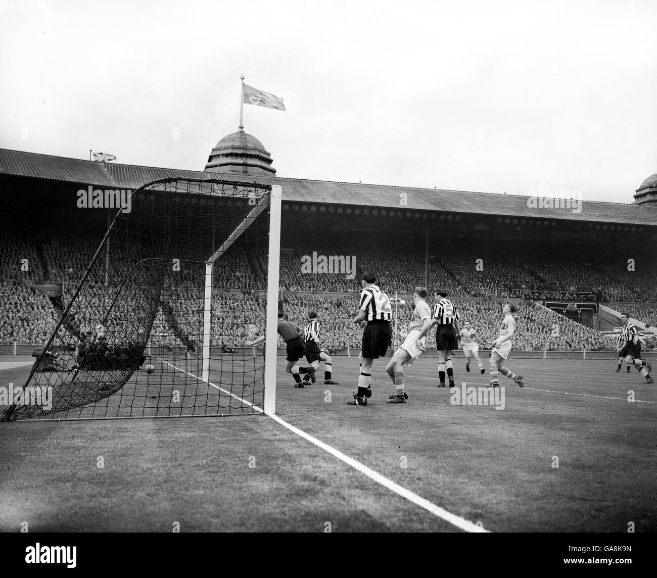 Joseph Hayes (extreme right) watches as his shot goes a few inches outside the Newcastle goal after a free kick taken by his Man City team mate, Captain Roy Paul. Stock Photo