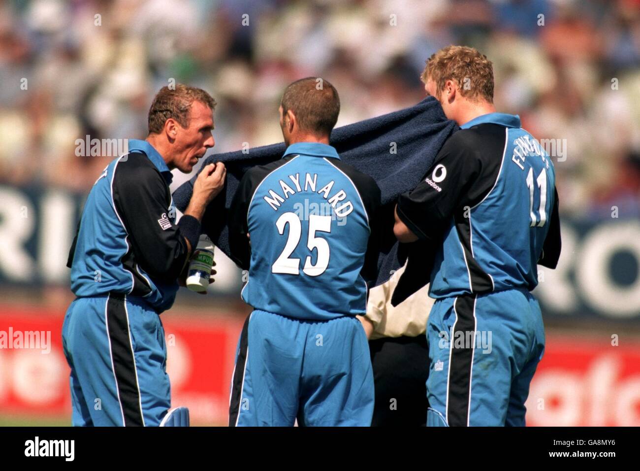 (L-R) England's Alec Stewart, Matthew Maynard and Andrew Flintoff wipe themselves down during the match Stock Photo