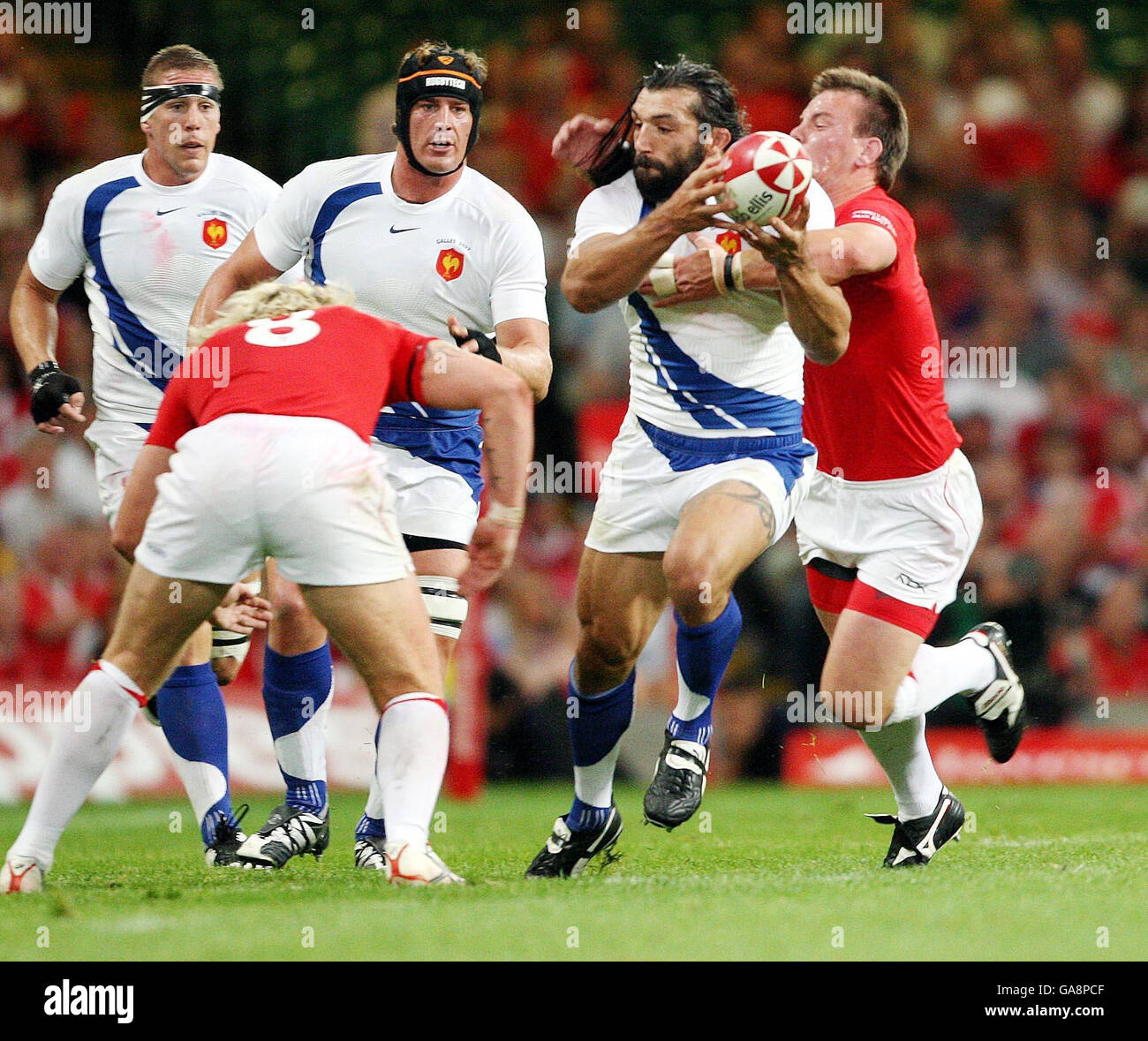 Wales's Matthew Rees and Alix Popham close in on France's Sebastien Chabal during the Invesco Perpetual Summer Series match at the Millennium Stadium, Cardiff. Stock Photo