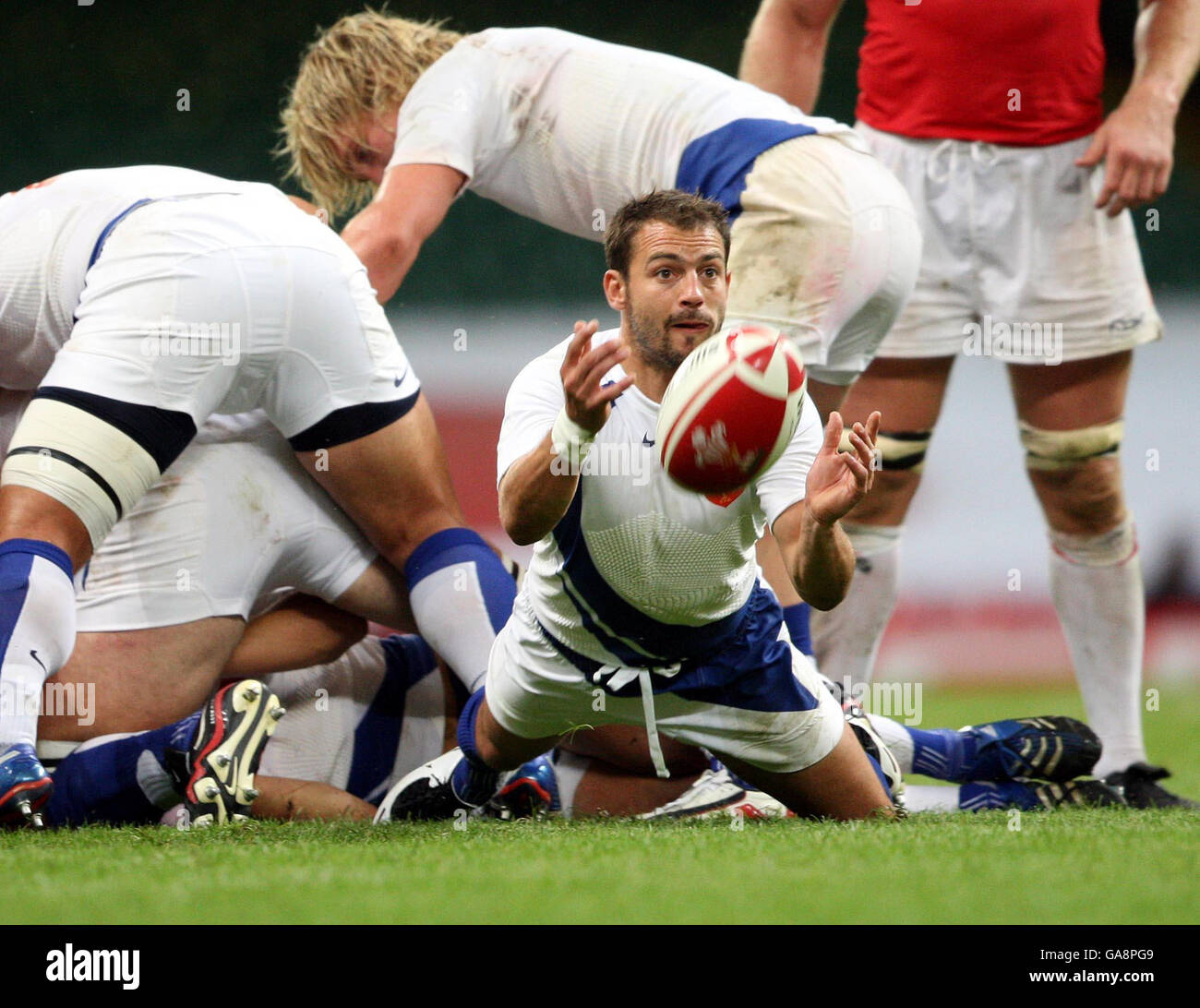 France's Jean Baptiste Elissalde feeds from a maul against Wales during the Invesco Perpetual Summer Series match at the Millennium Stadium, Cardiff. Stock Photo