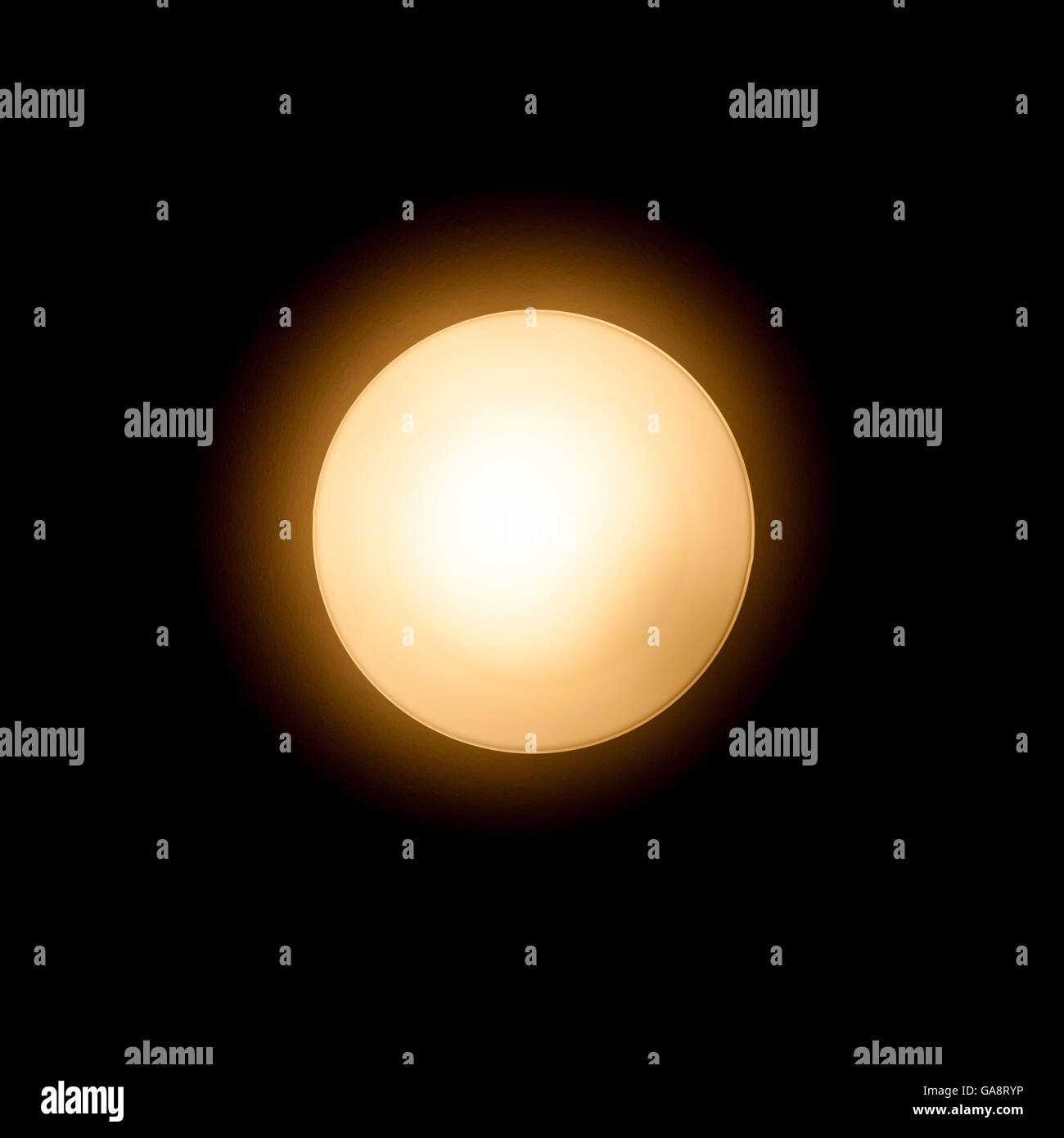 Tungsten lamp glowing over black background, closeup photo Stock Photo