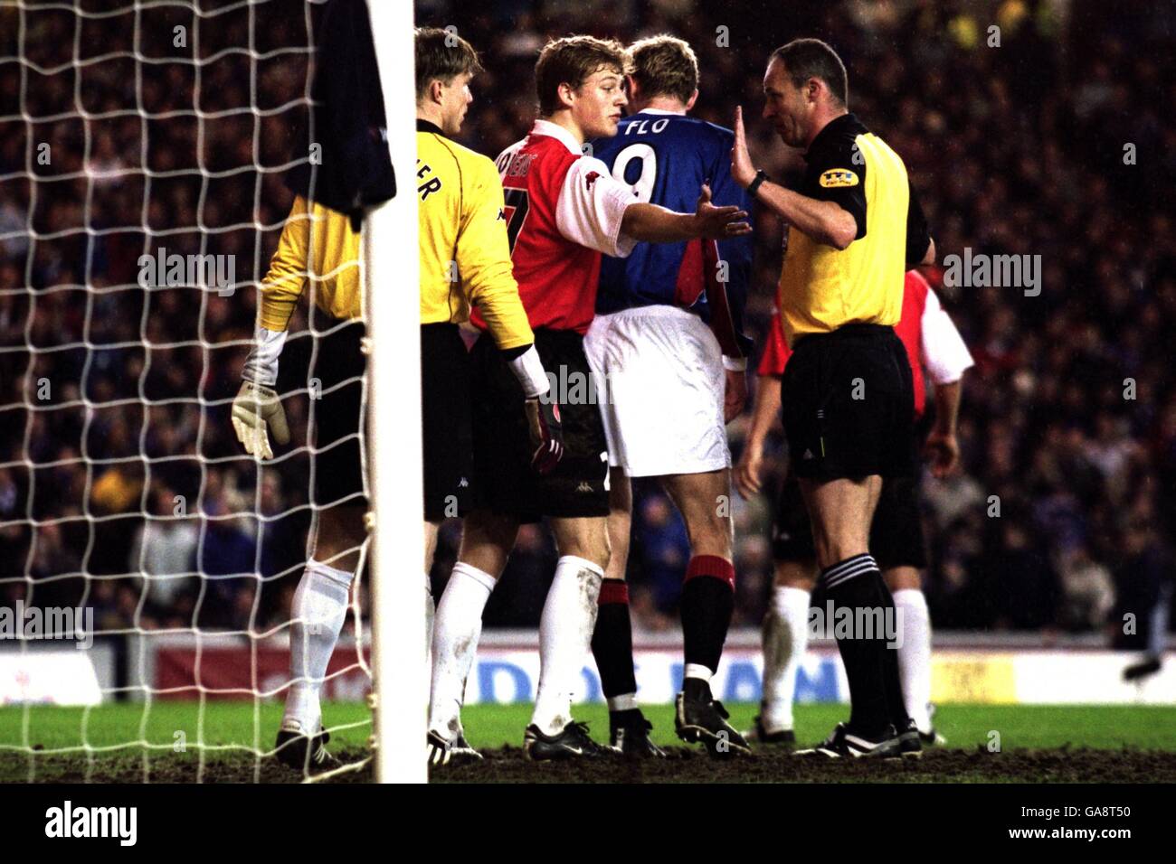 Soccer - UEFA Cup - Fourth Round - First Leg - Rangers v Feyenoord. L-R: Feyenoord's goalkeeper Edwin Zoetebier, Glenn Loovens and Rangers Tore Andre Flo argue with referee Eric Poulat Stock Photo