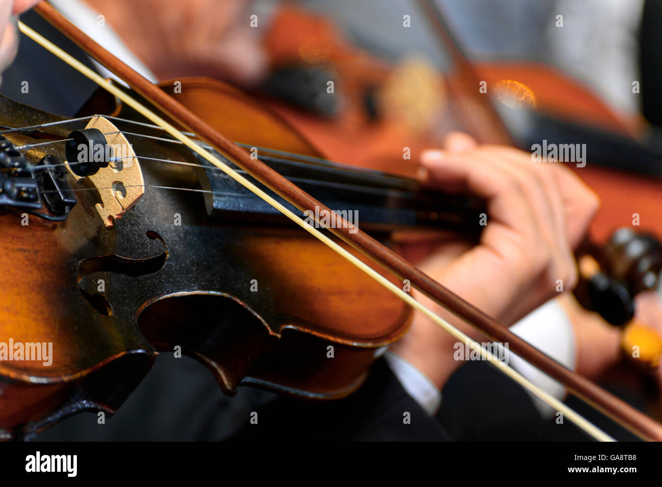 Closeup of  Musician Playing The Violin During a Symphony Stock Photo