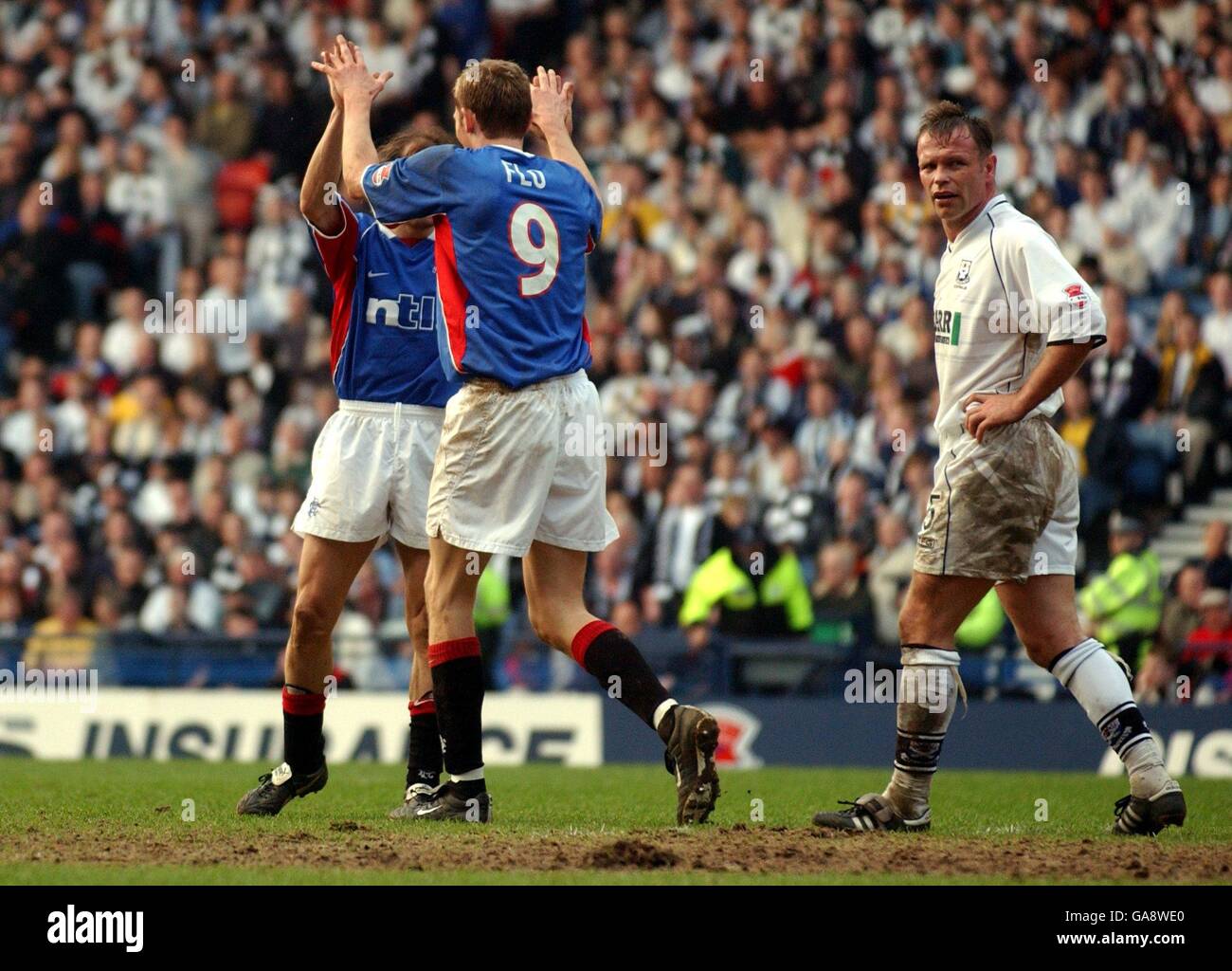 A dejected John Hughes of Ayr watches Rangers' Claudio Caniggia and Tore Andre Flo celebrate the fourth goal Stock Photo