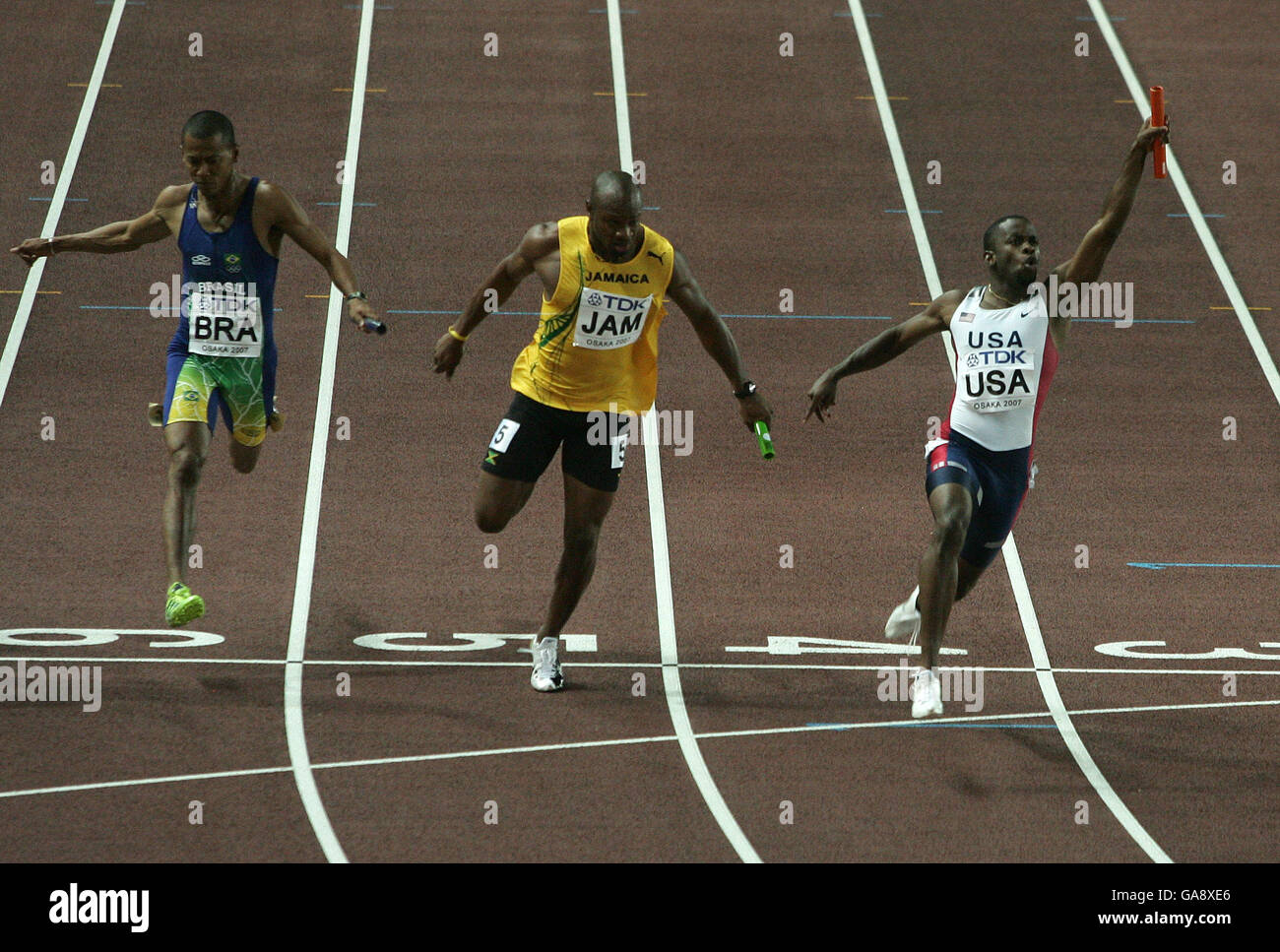 USA Leroy Dixon crosses the line ahead of Jamaica's Asafa Powell to help win Gold in the Men's 4x100m Relay Stock Photo